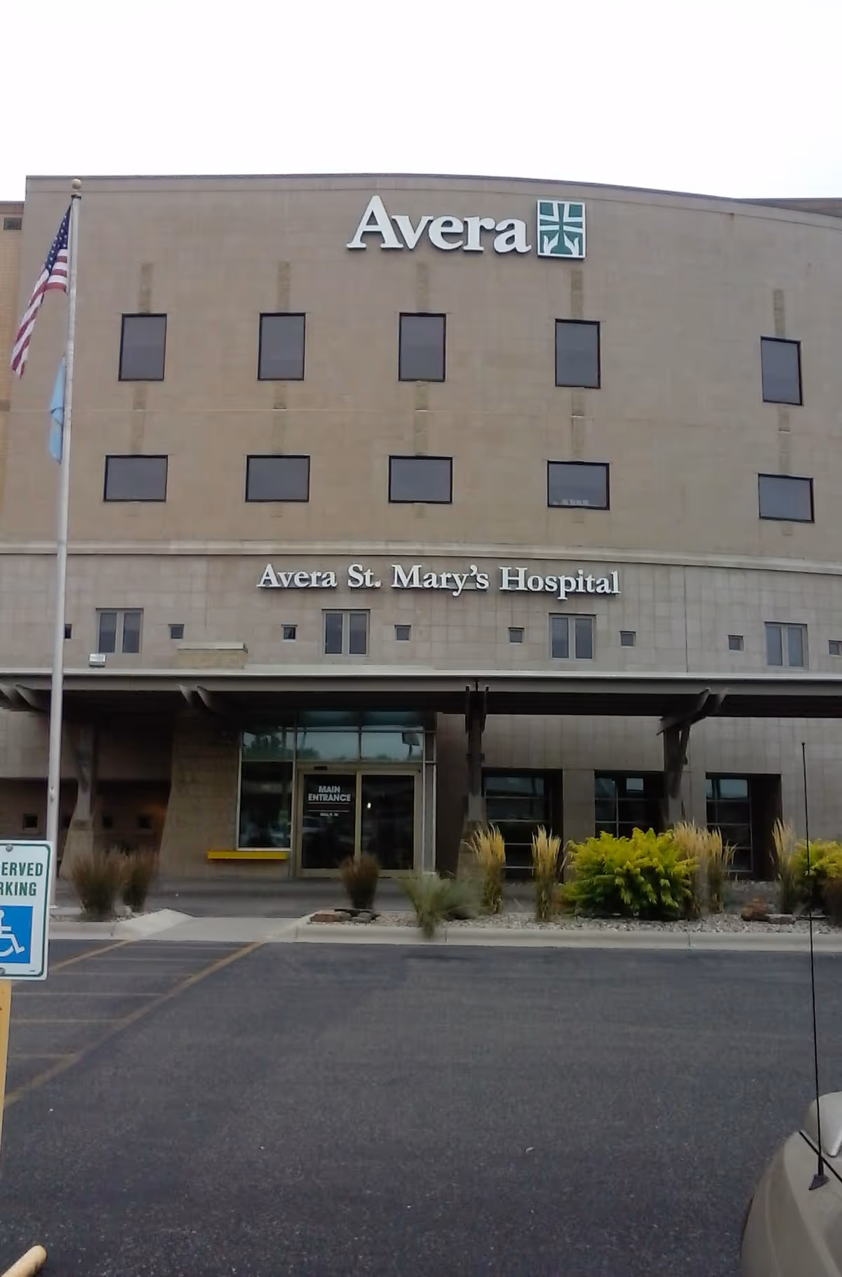 Front exterior of Avera St. Mary's Hospital with entrance, signage, and flag.