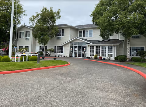 Exterior view of Neawanna By The Sea senior living facility with a curved driveway and entrance.