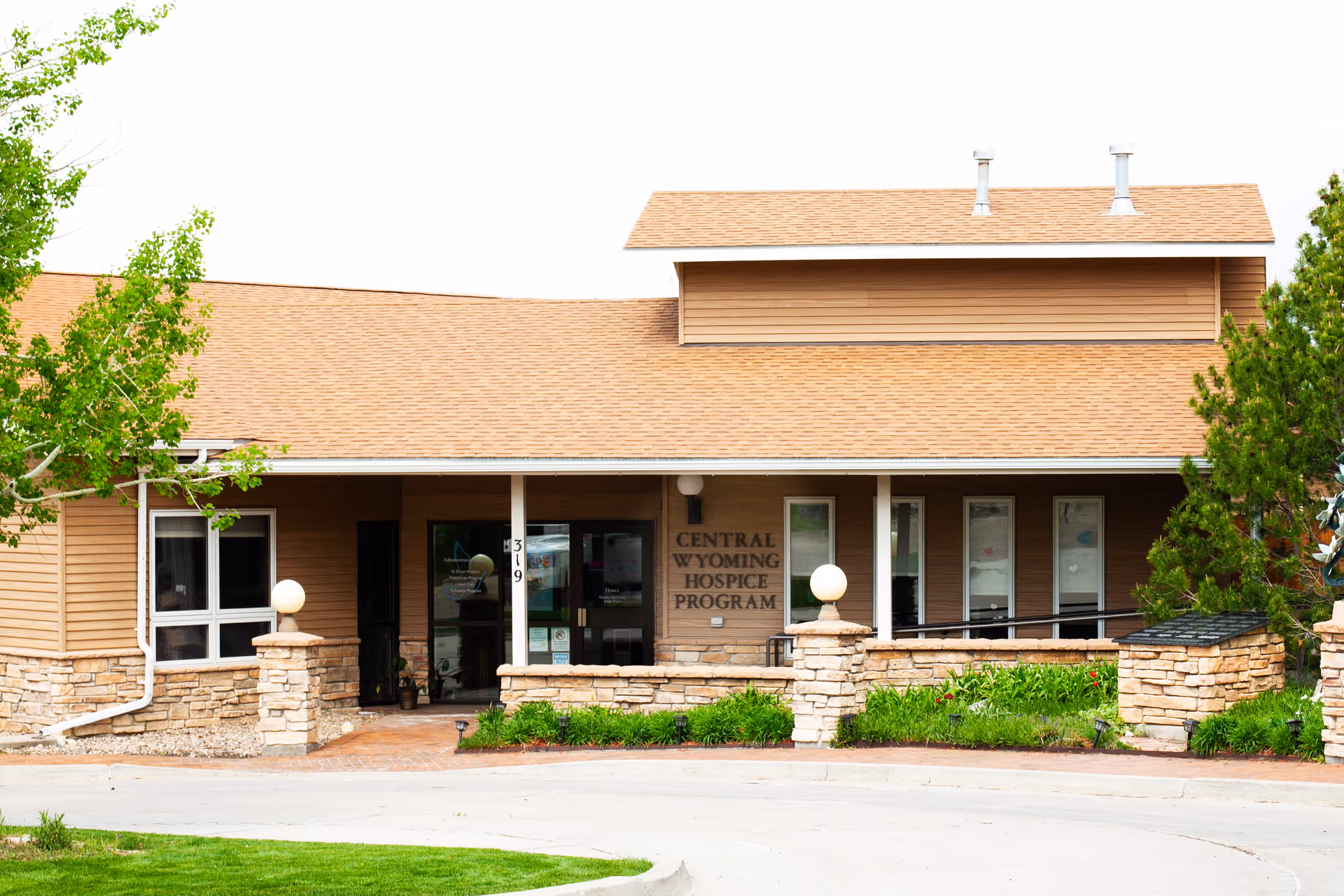 Front view of Central Wyoming Hospice Program building with stone accents and glass entrance.