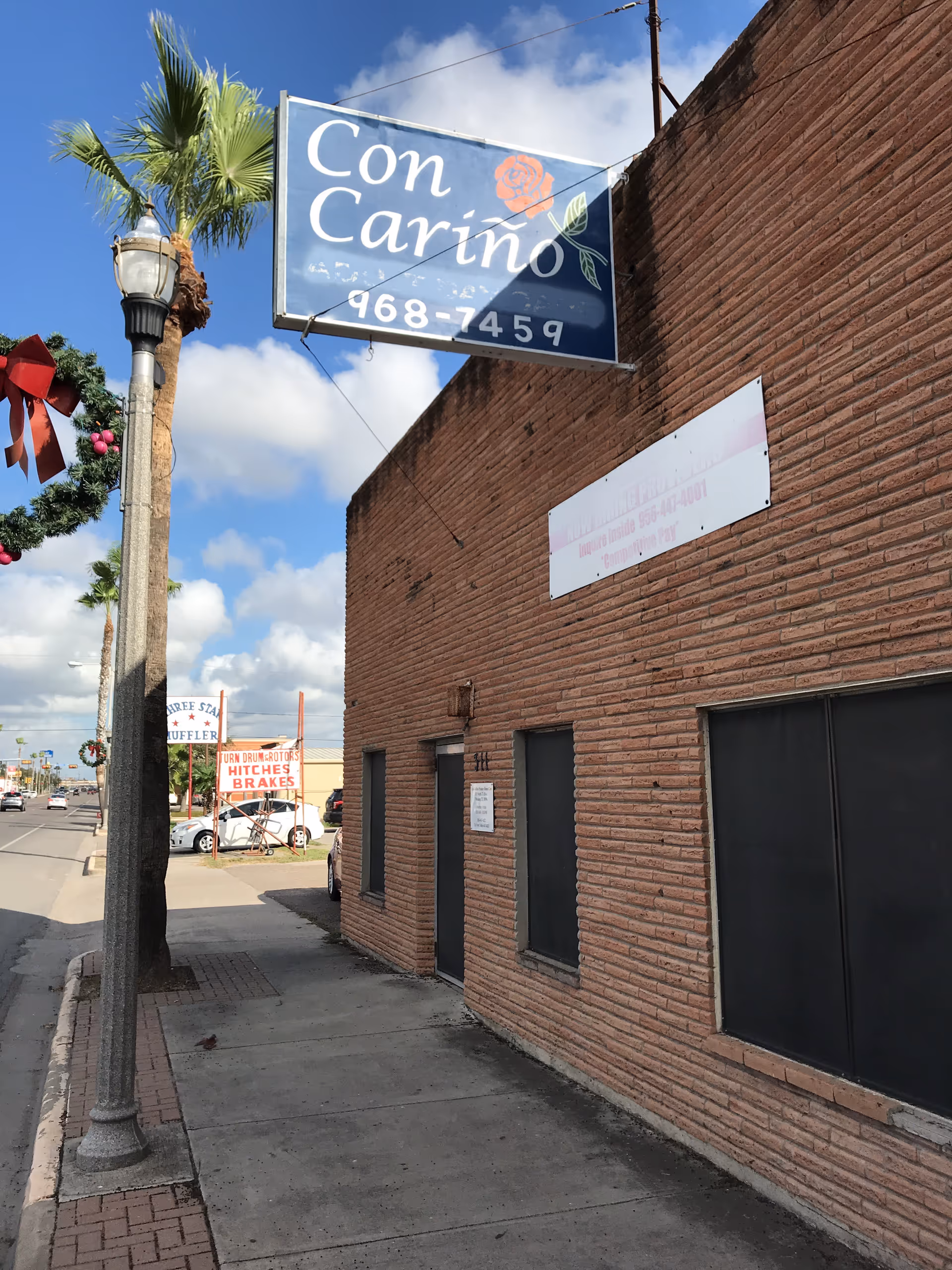 Front exterior of Con Carino Primary Home Care building with sign.