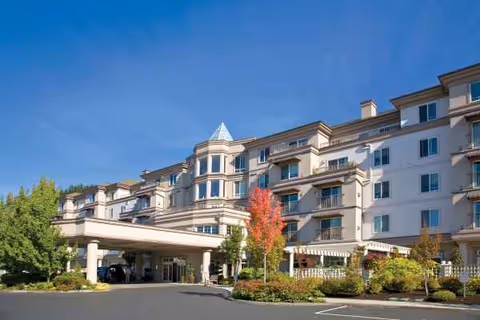 University House Issaquah senior living building with a covered entrance and landscaped grounds.