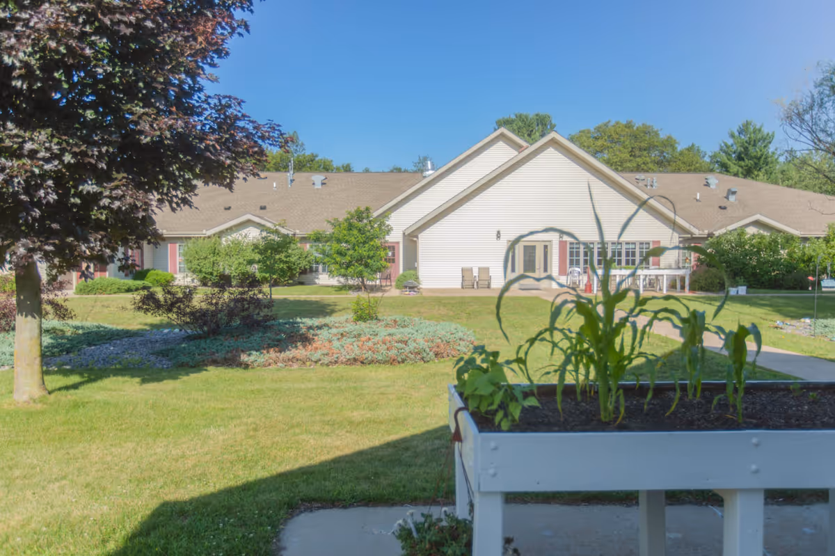Exterior view of Cranberry Court Assisted Living with a manicured lawn and entrance.