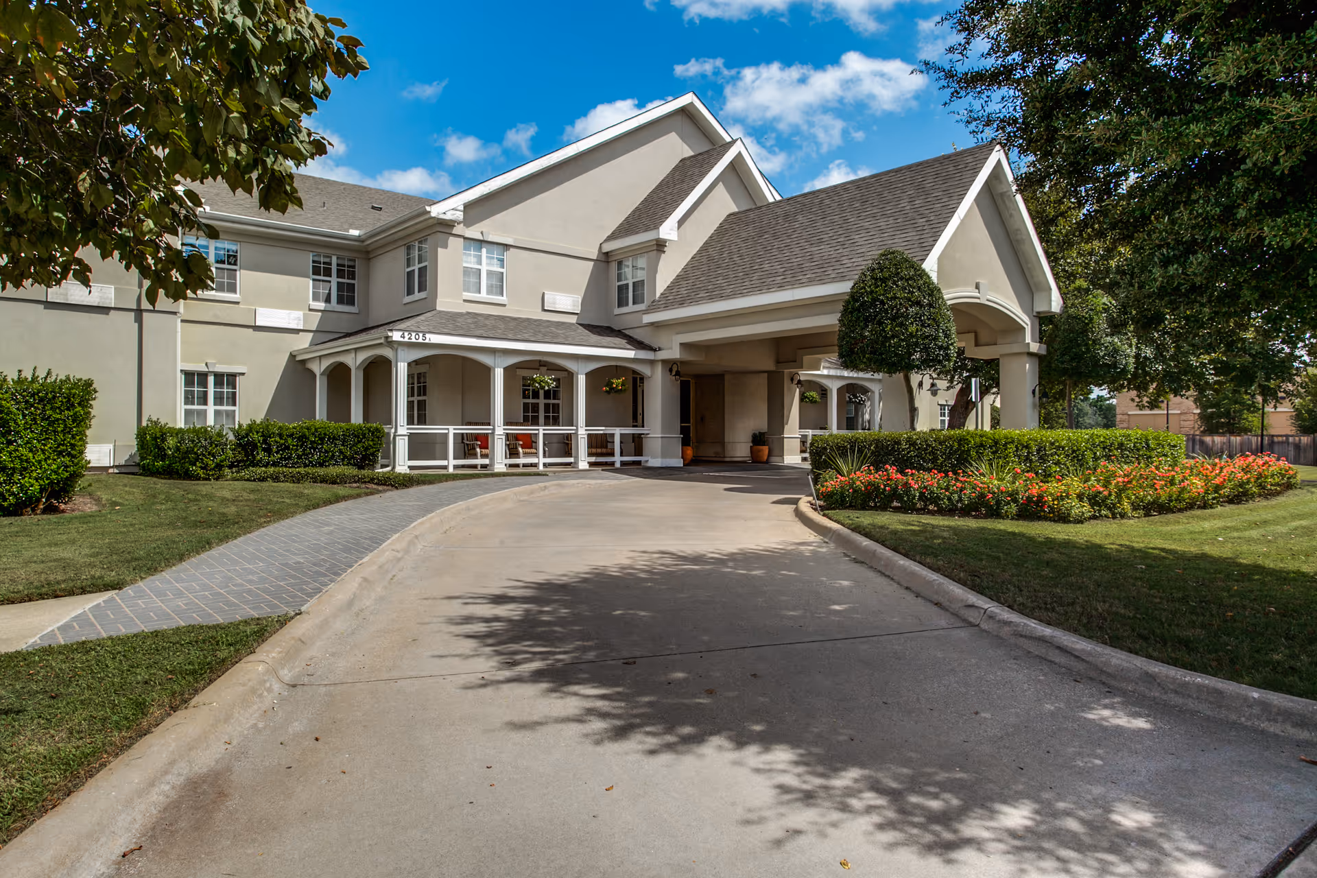 Front exterior of Parsons House Preston Hollow with entrance, driveway, and landscaped grounds.
