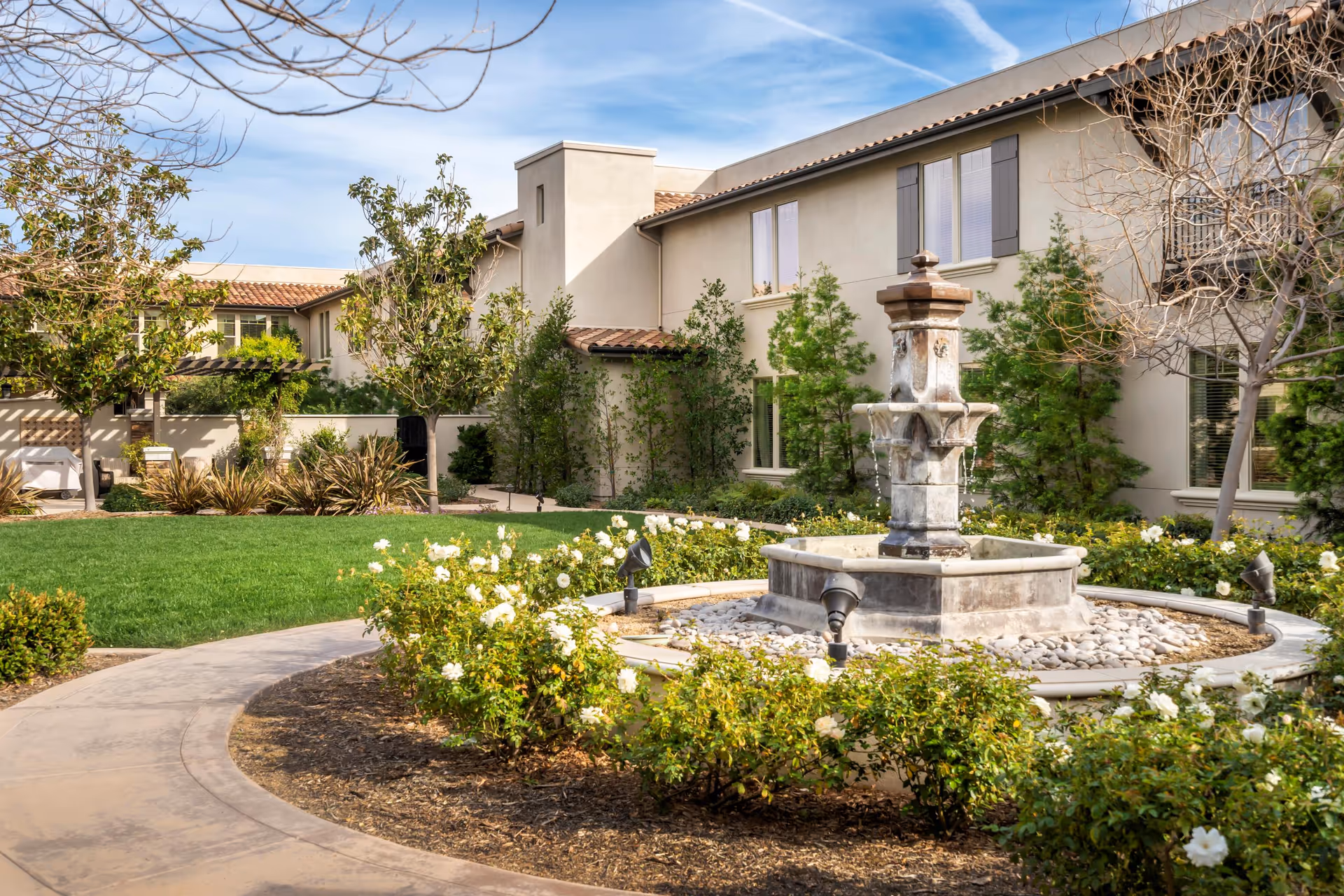 Exterior view of Oakmont of Santa Clarita with a central fountain and landscaped courtyard.