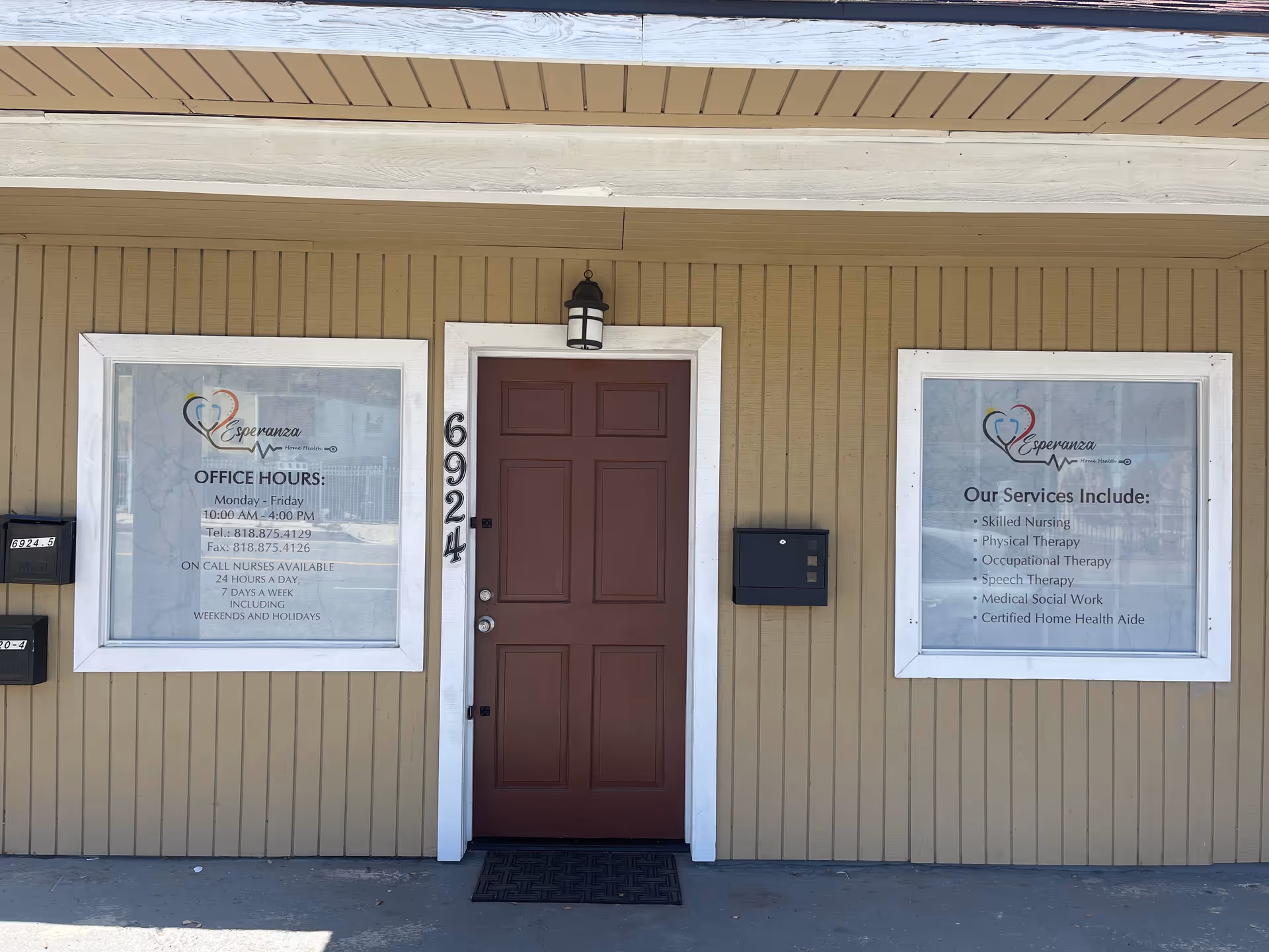 Front entrance of Esperanza Home Health, Inc., with two windows and a brown door.