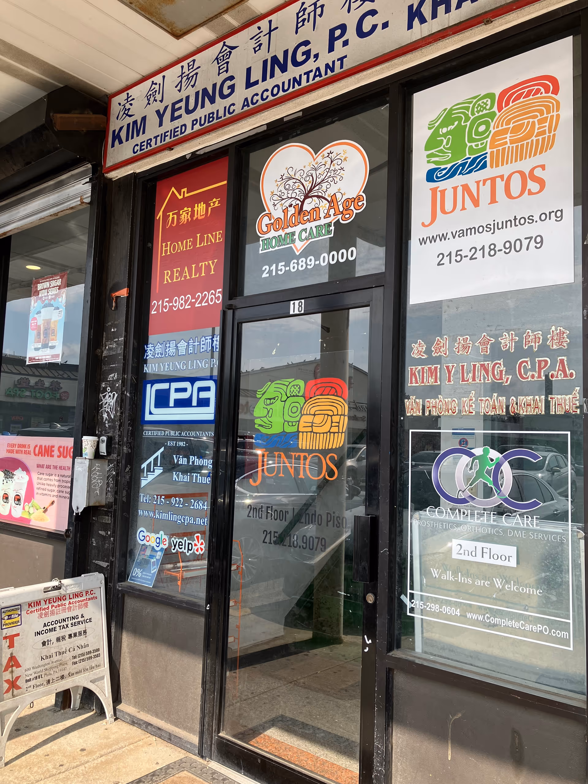 Storefront of Golden Age Home Care, Inc. with multiple business signs displayed on glass doors.