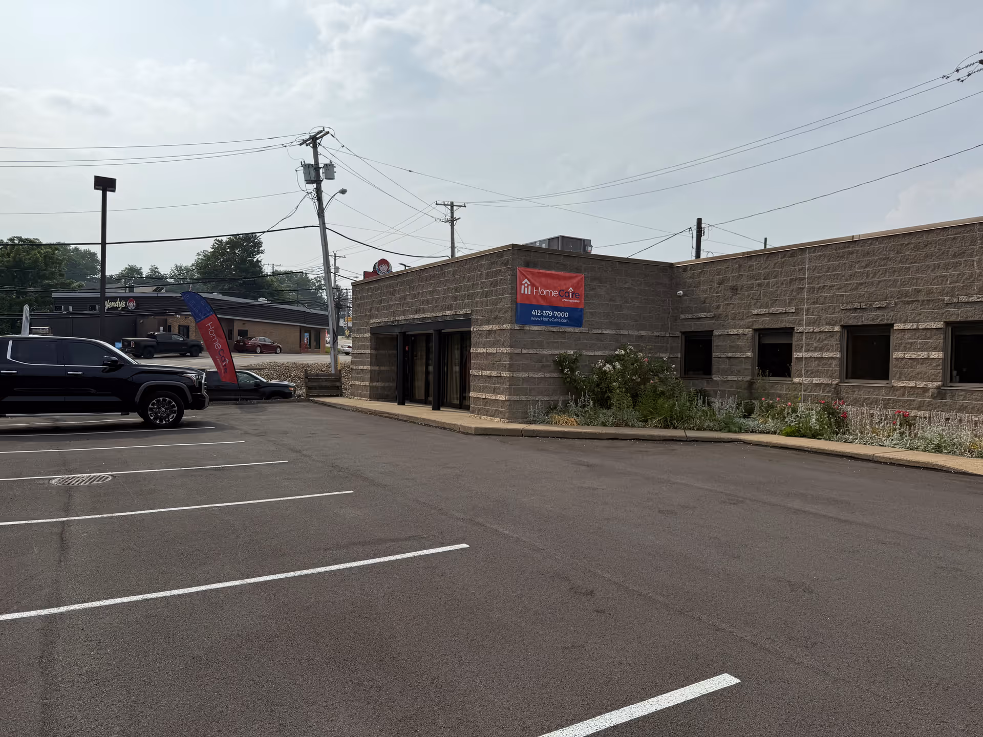 Exterior view of HomeCaire of Pennsylvania facility with parking lot and entrance.