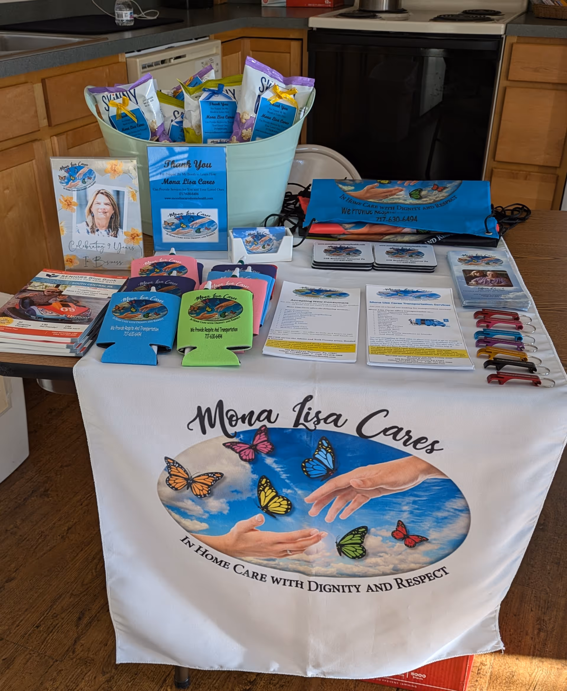 Promotional display on a kitchen table featuring Mona Lisa Cares materials and butterfly logo.