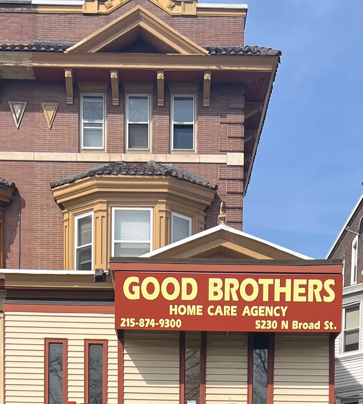 Brick building exterior with a large red sign reading Good Brothers Home Care Agency.