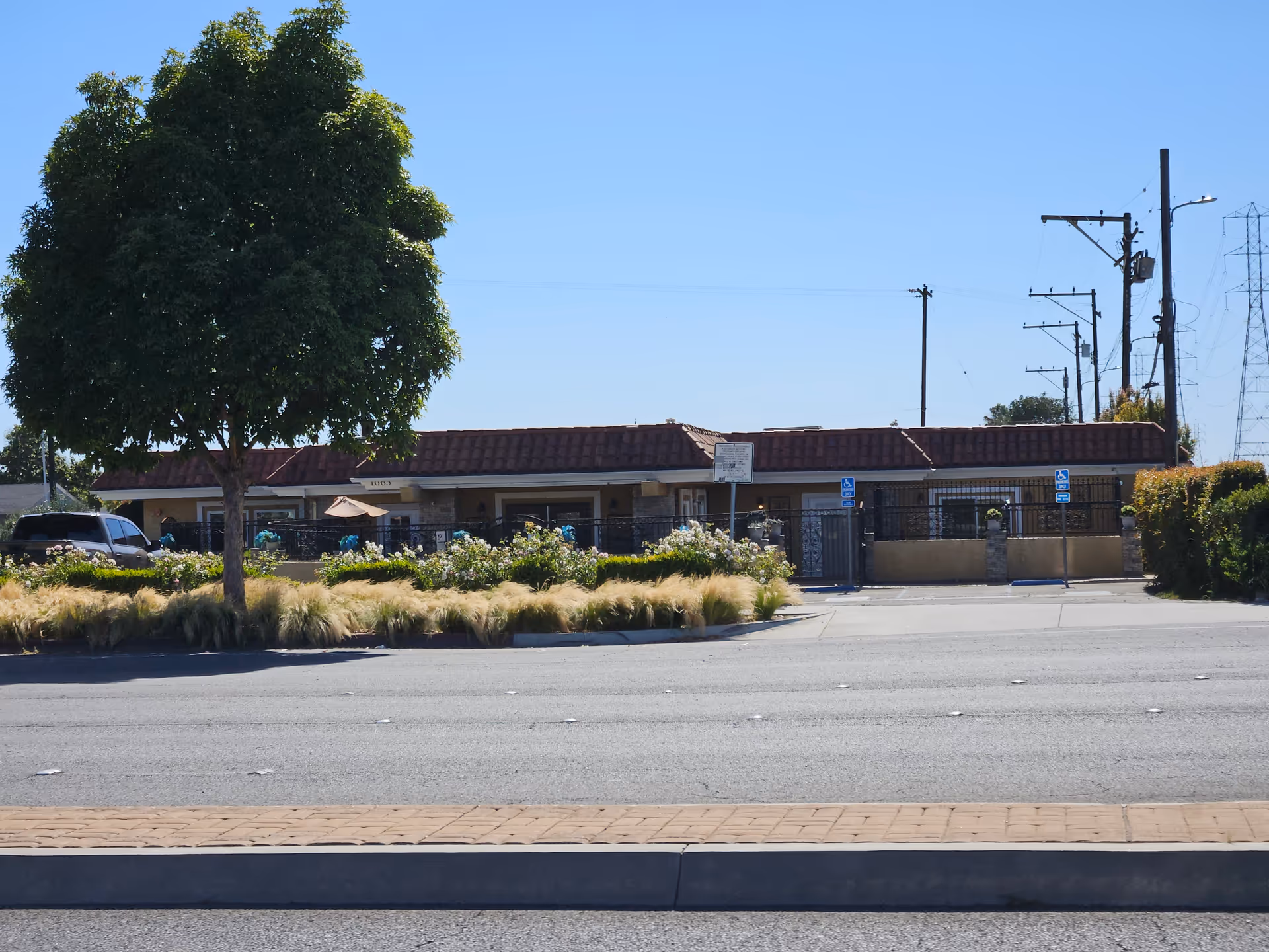Front exterior of a single-story building with a manicured landscape.