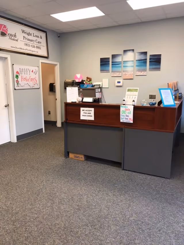 Interior reception area of a senior living facility with a front desk and holiday decor.