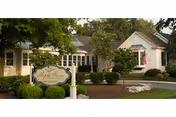 Front exterior view of Maple Farm Nursing Center with landscaping and a sign.