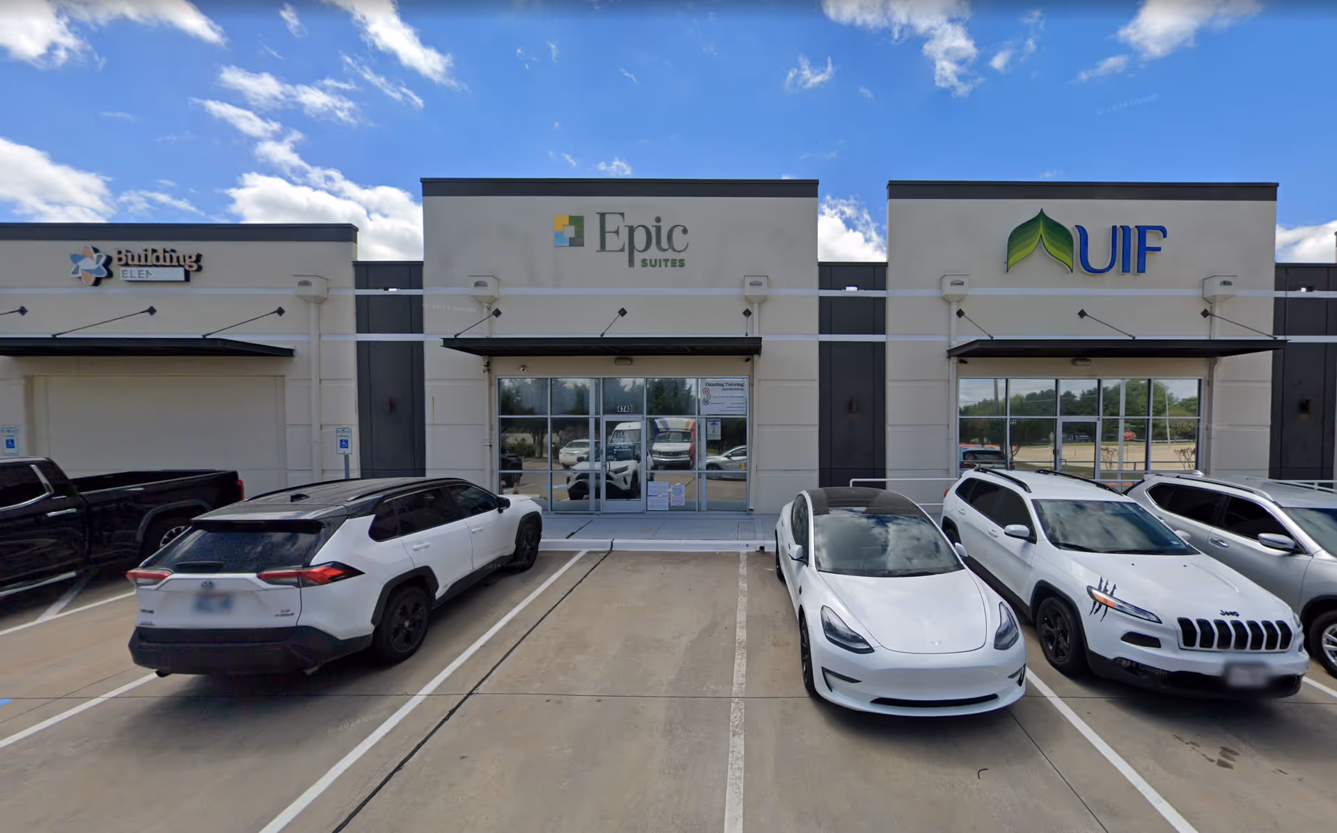Exterior view of a commercial building with Epic and UIF signage and parked cars.