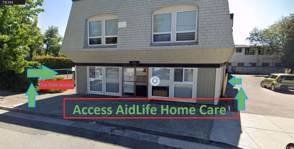 Exterior view of a two-story building with glass doors and 'Access AidLife Home Care' signage.