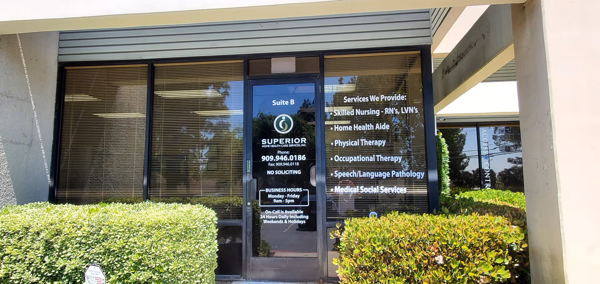 Entrance with glass doors, signage for Superior Home Health Care, and trimmed hedges.