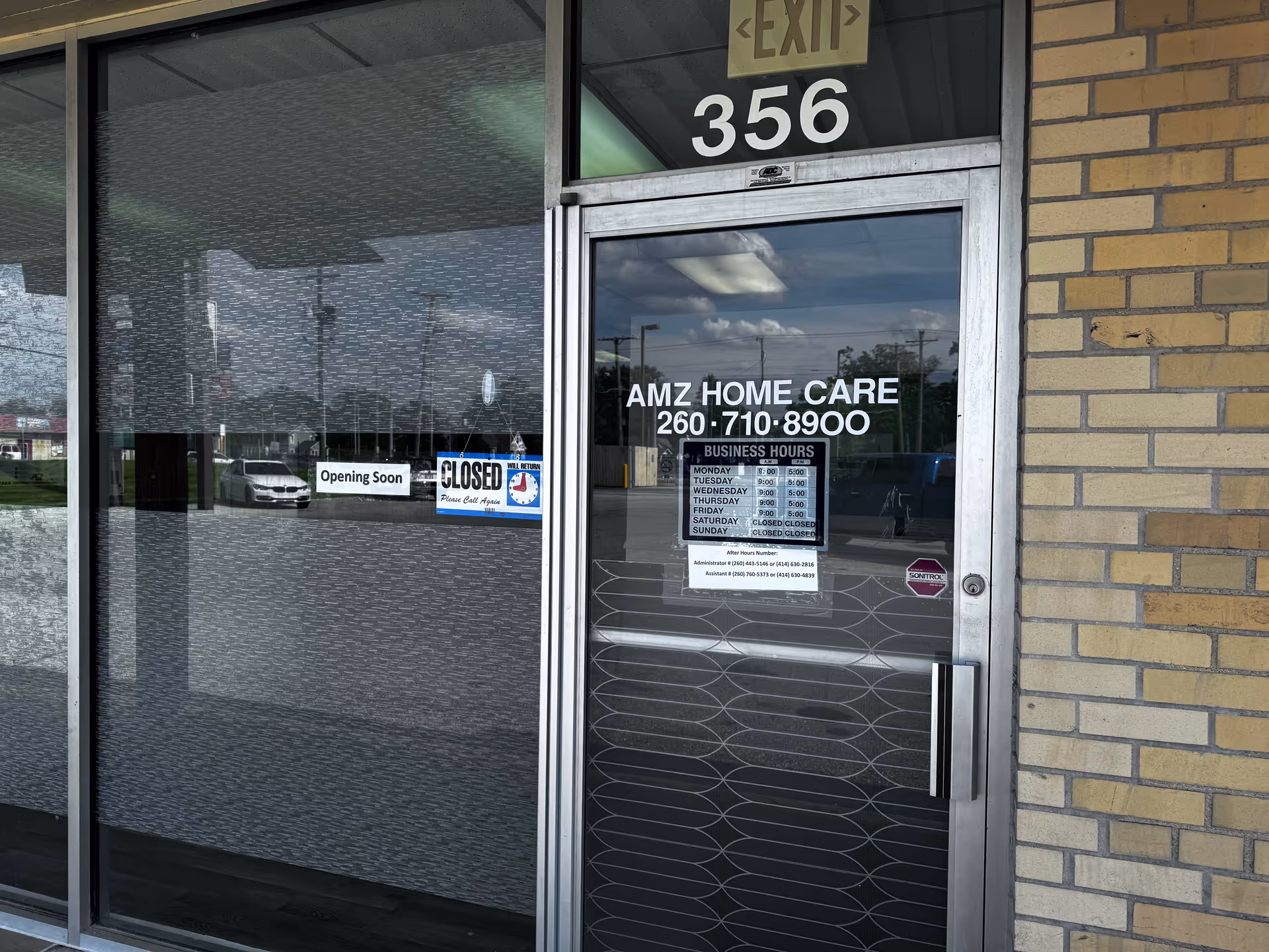 Glass door entrance to AMZ Home Care with hours, 'Opening Soon' and 'Closed' signs