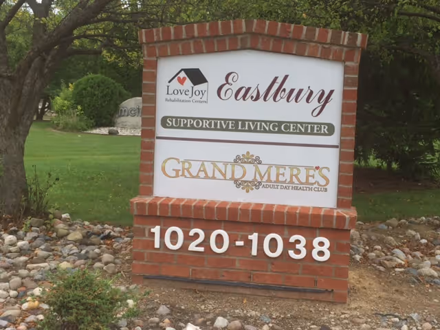 Brick sign for LoveJoy Eastbury, showing supportive living center and Grandmères adult day health club.