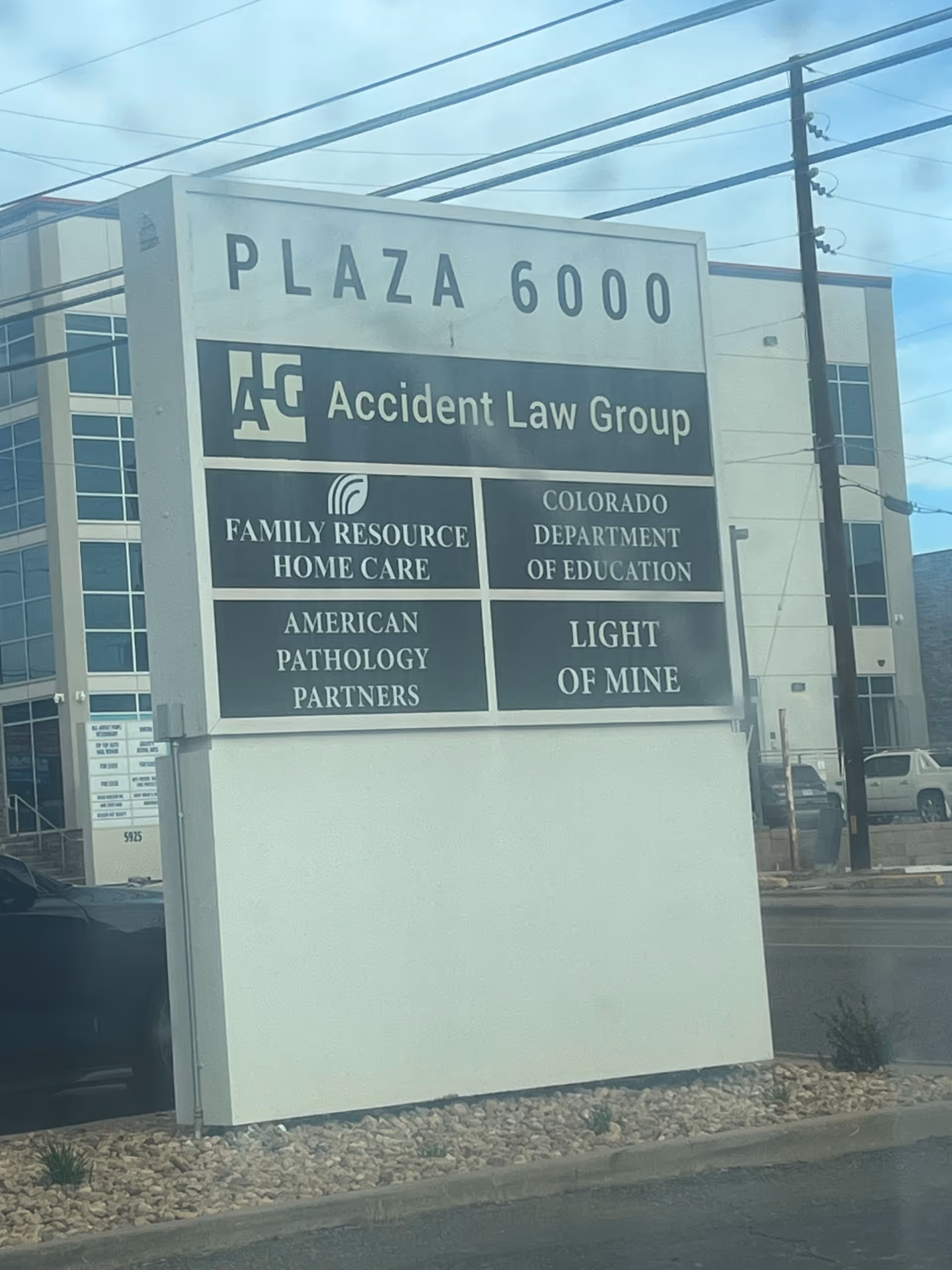 A large outdoor plaza sign lists tenants including Family Resource Home Care.
