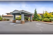 Entrance to Mountain Glen Retirement and Assisted Living with a covered drive and landscaped grounds.