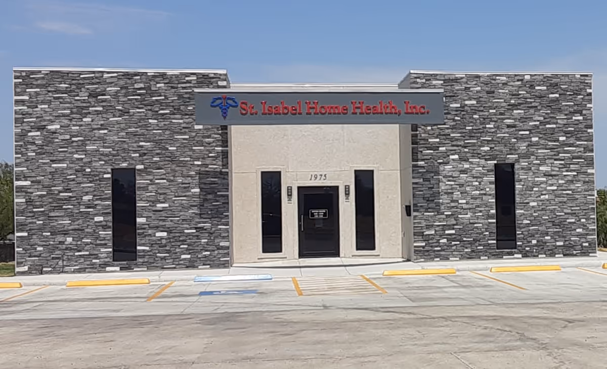 Stone-clad facility entrance with St Isabel Home Health sign and parking lot.