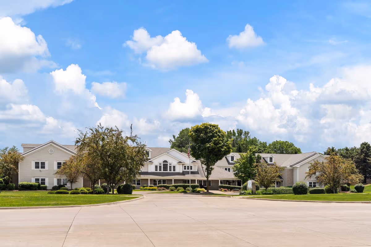 Exterior view of Brookdale Northville with a manicured lawn and blue sky.