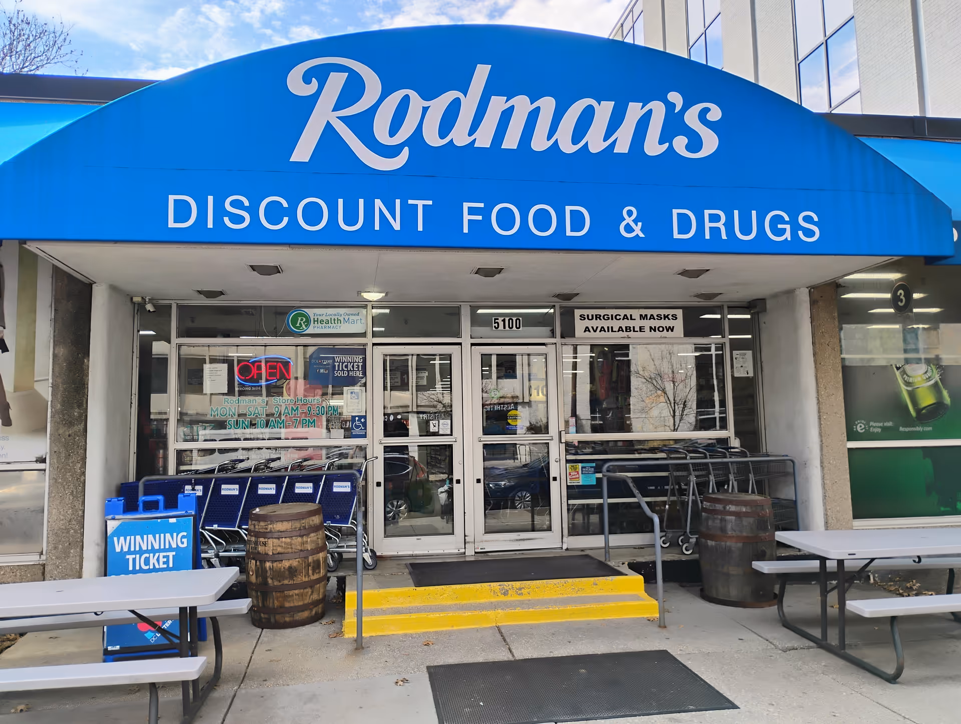 Rodman's Discount Food & Drugs storefront with blue curved awning and carts outside.