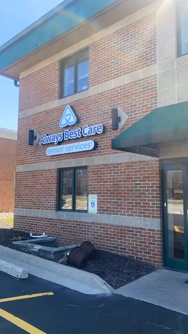 Brick building facade with Always Best Care sign and green awning.