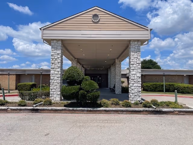 Senior Care Beltline facility exterior with a covered entryway and stone pillars.