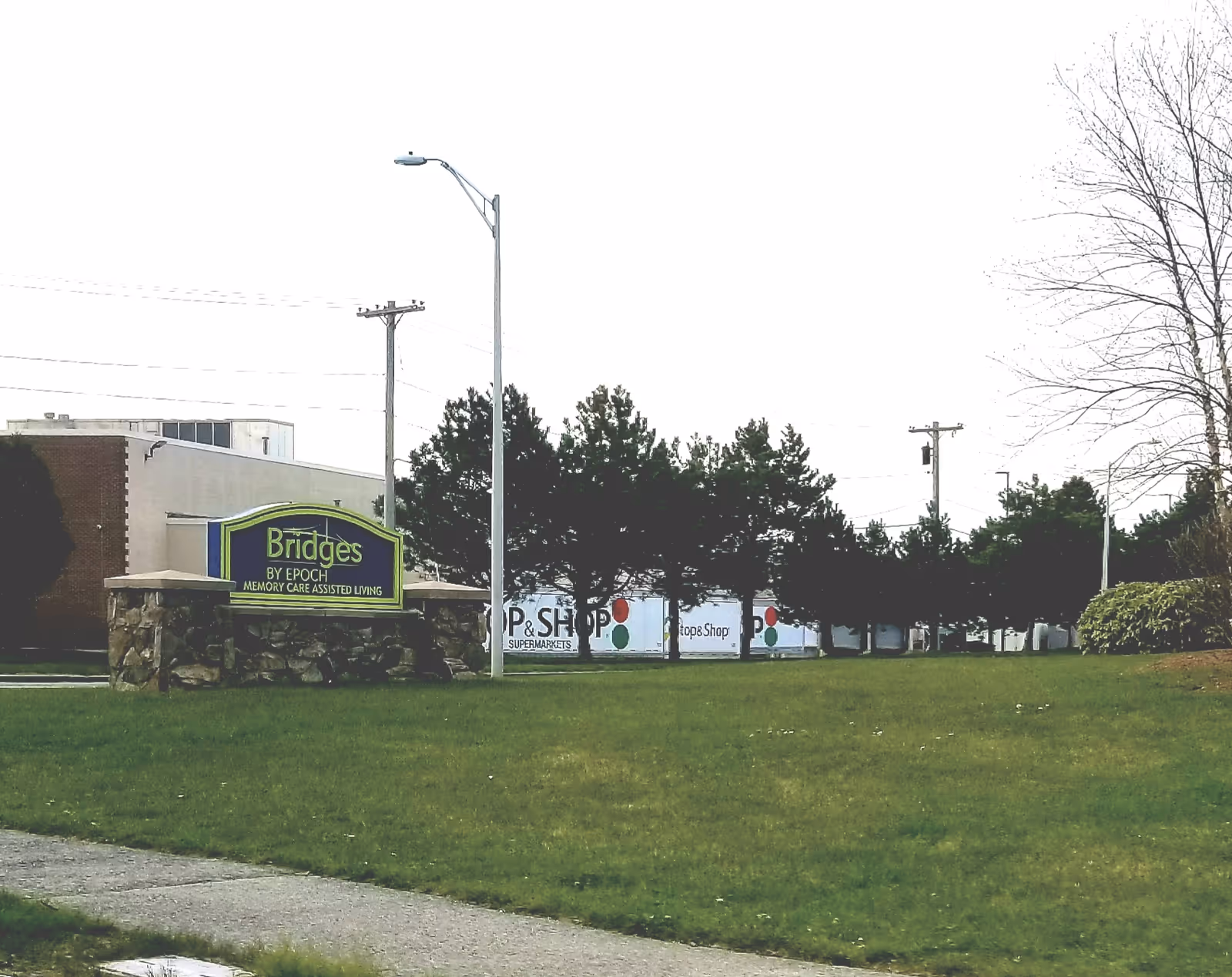 Exterior view of Bridges by Epoch at Lexington with the front sign and lawn.