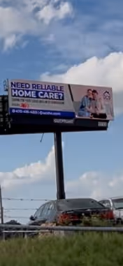 Roadside billboard reads 'Need reliable home care?' with a couple against a blue sky.