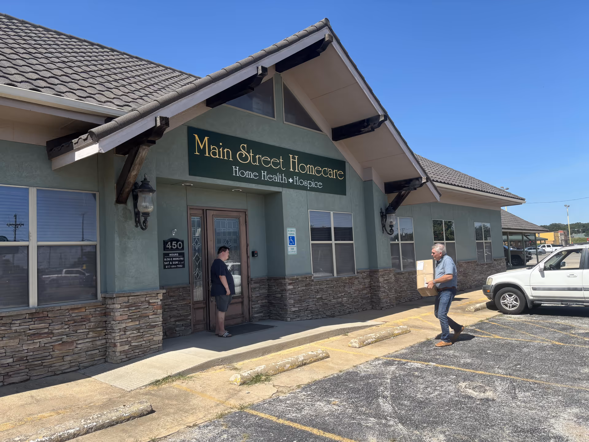 Exterior view of Main Street Homecare building with two people near the entrance.