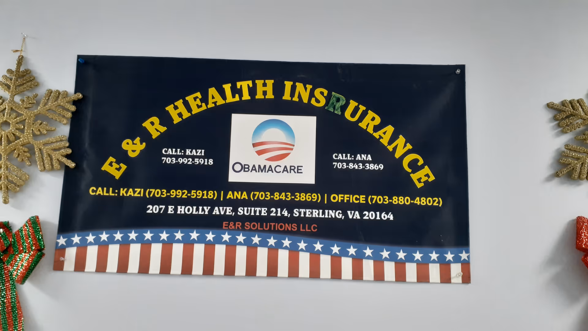 Banner advertising Obamacare hangs on an interior wall with holiday decorations.
