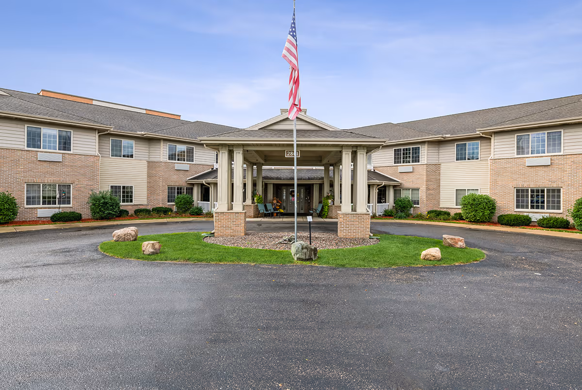 Exterior view of LakeHouse Chippewa Falls showing entrance canopy and flagpole.