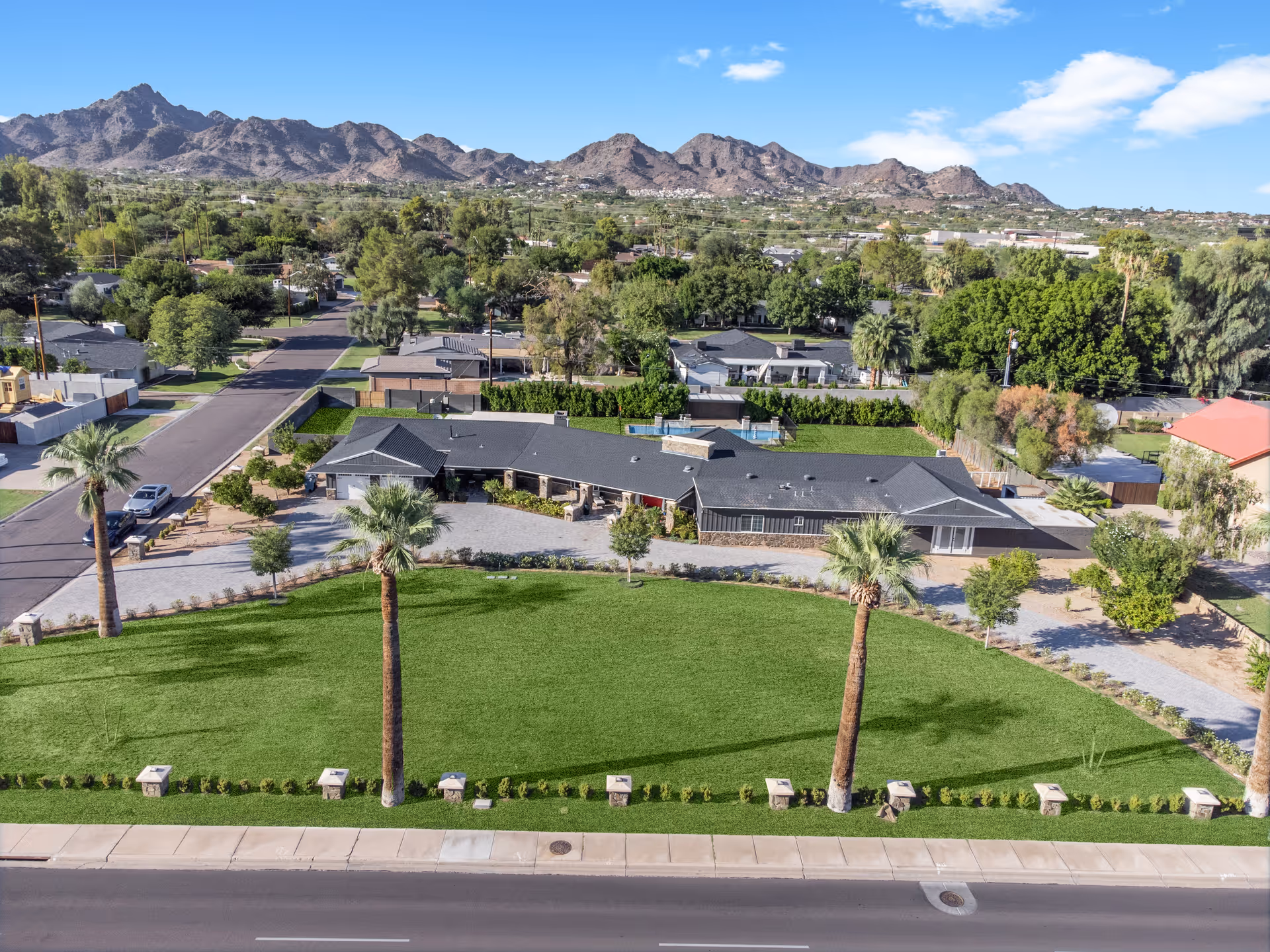 Aerial view of Liftimo Residential Assisted Living Arcadia campus with green lawns and palm trees.