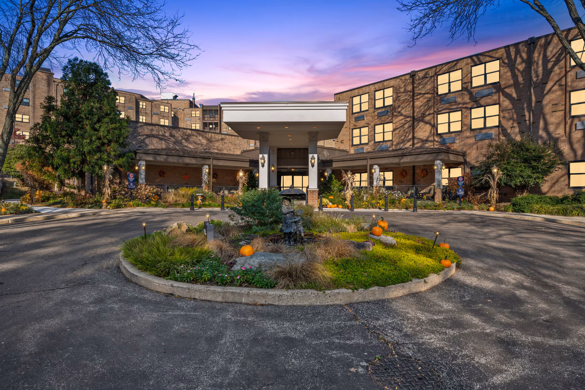 The Lafayette Independent Living exterior shows a circular driveway and landscaped front entrance.