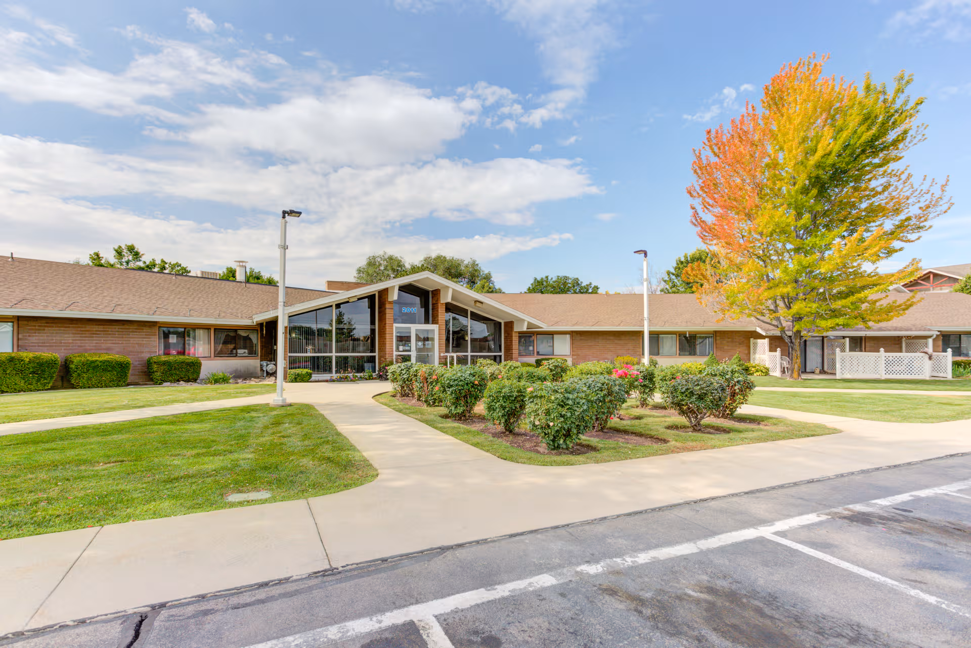 Exterior view of Truewood by Merrill, Taylorsville, with entrance and landscaped walkway.