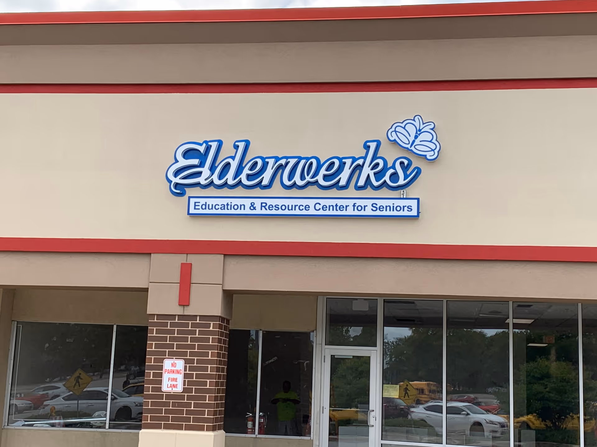 Exterior view of Elderwerks building with logo sign and glass entry doors.