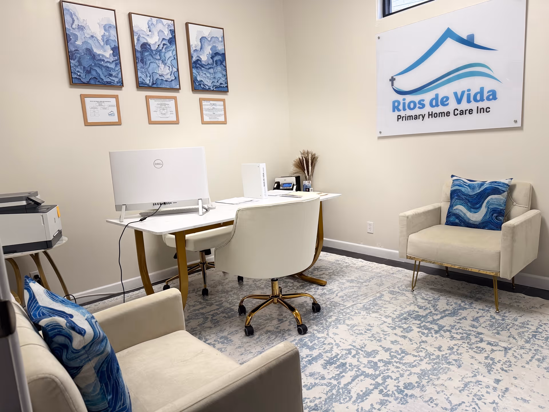Interior office space with desk, computer, printer, and waiting chairs at Rios de Vida facility.