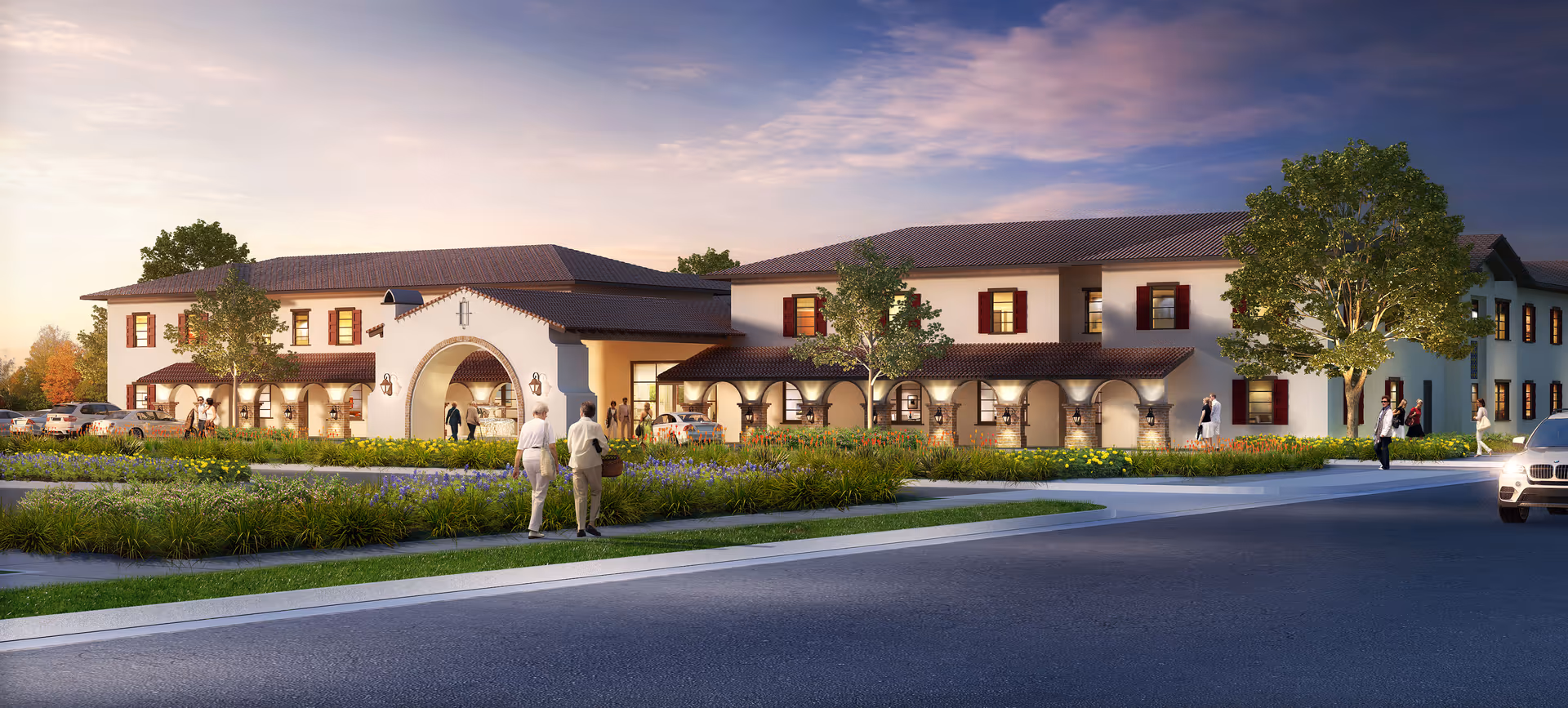 Exterior view of Regency Palms Palmdale with a landscaped entrance and vehicles.