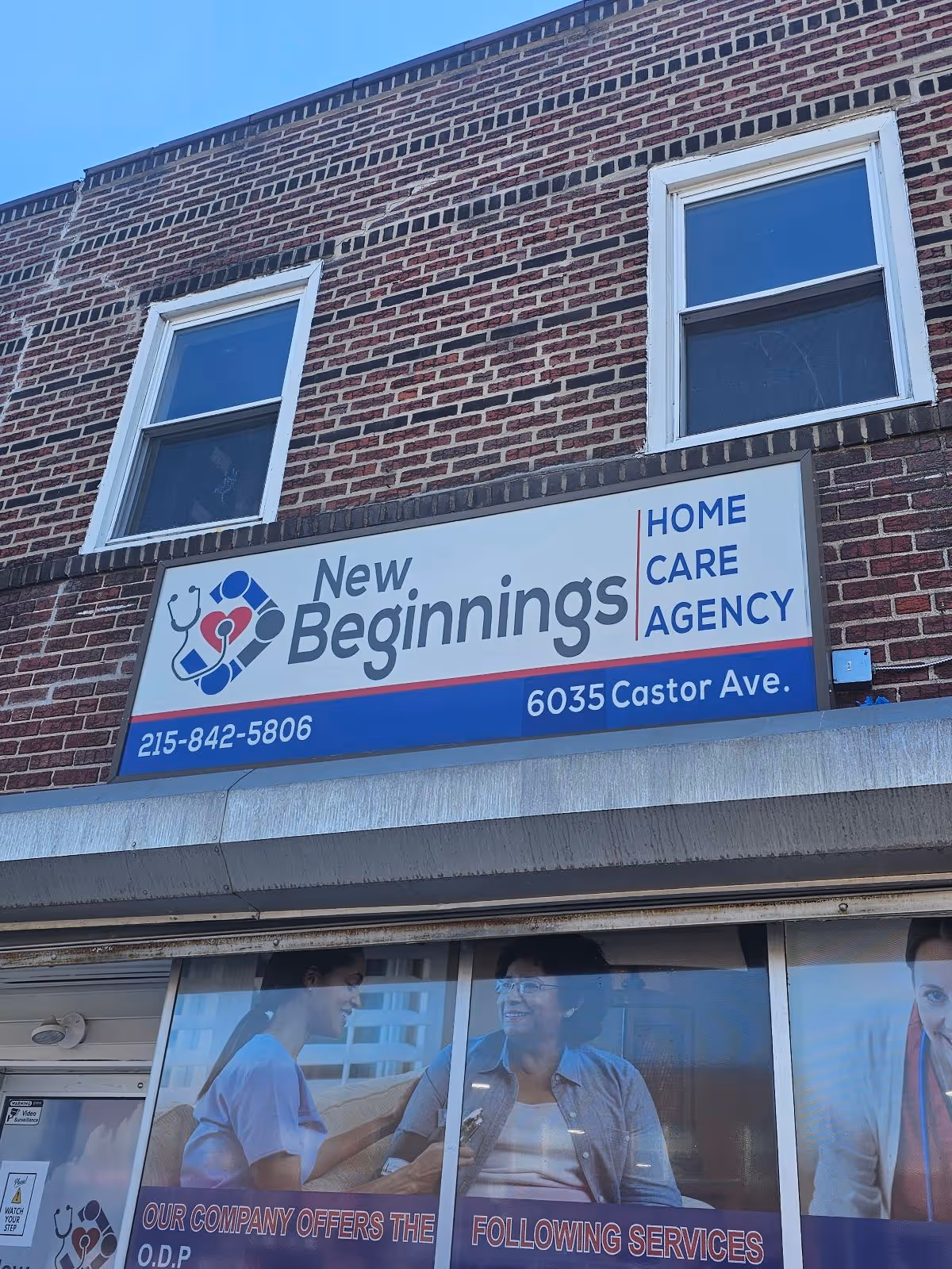 Brick building storefront displaying New Beginnings Home Care Agency sign above two windows.