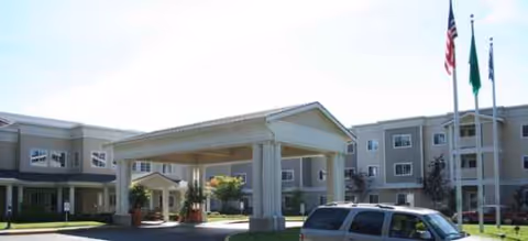 Exterior view of Brookdale Foundation House with porte-cochère entrance and a parked vehicle.