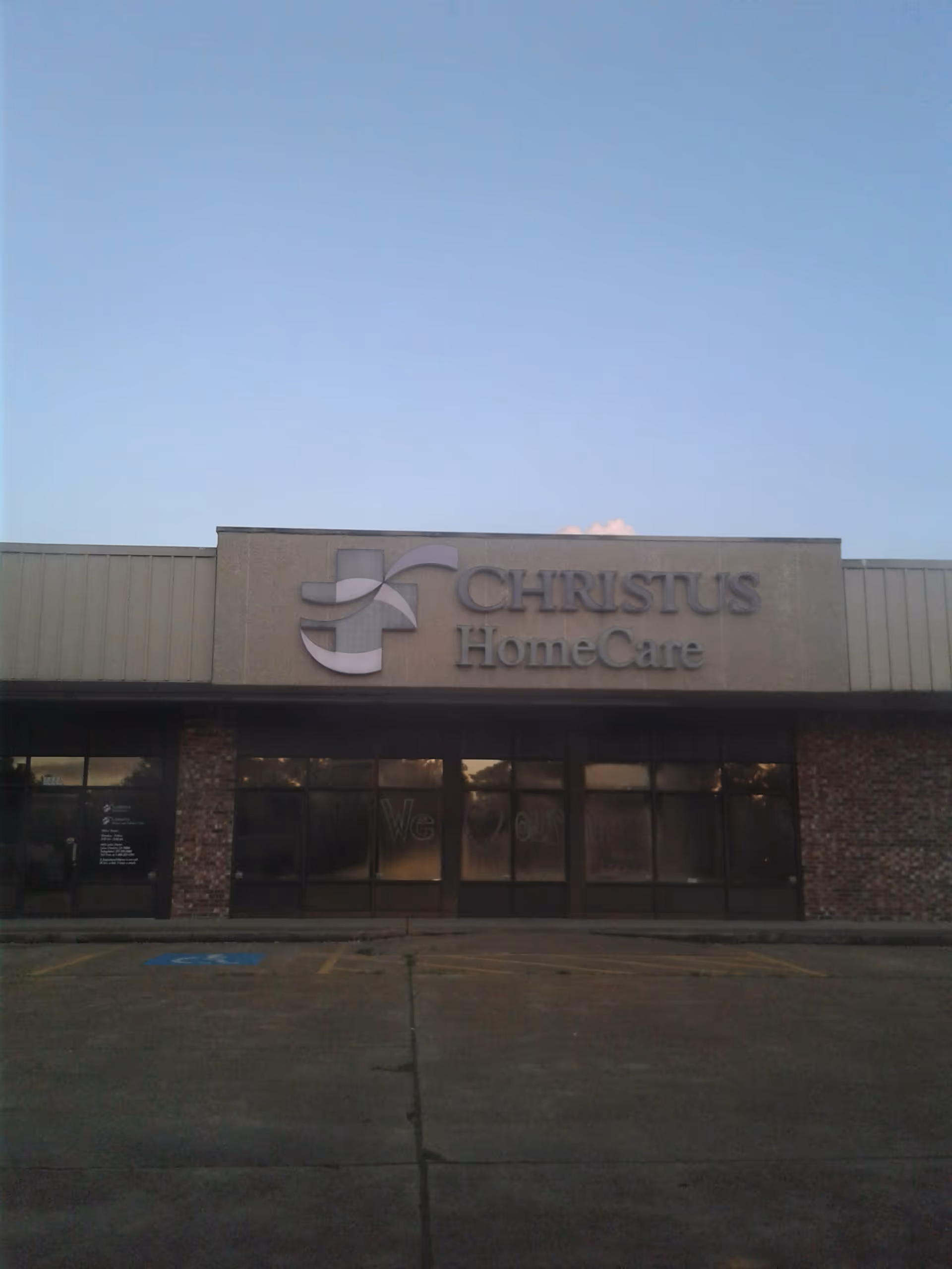 Front exterior of Christus HomeCare building with sign and glass storefront.