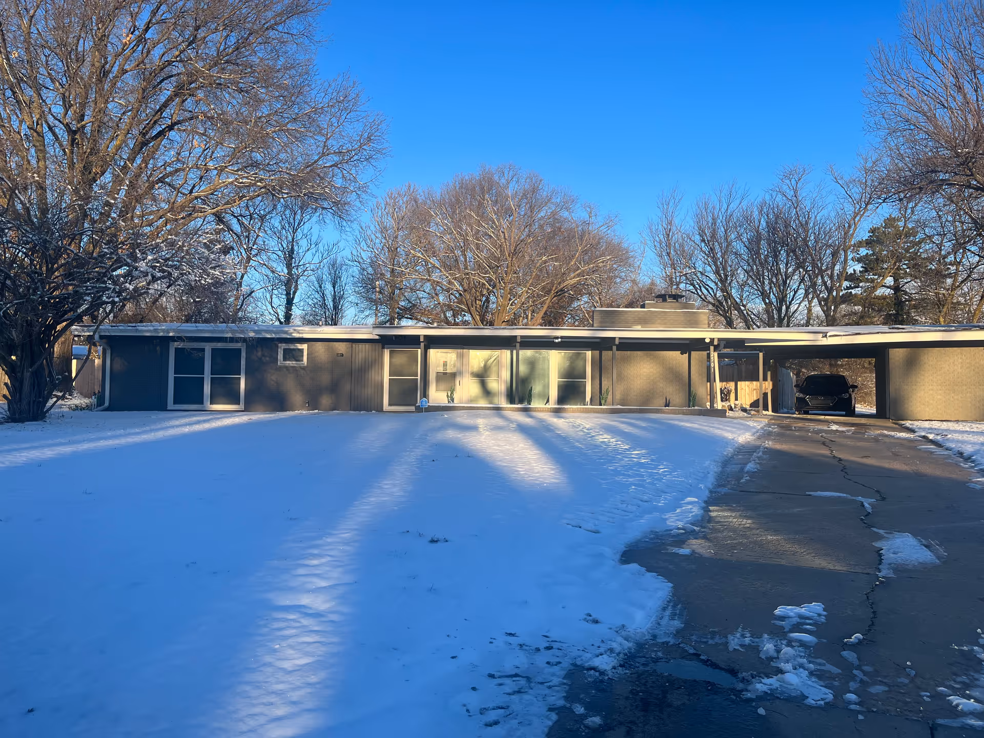 Single-story exterior of Azara Home Health with snow-covered lawn and driveway.
