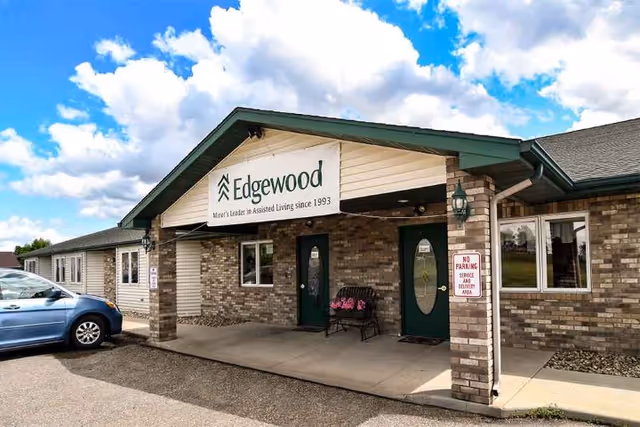 Exterior view of Edgewood memory care facility with brick facade and signage.