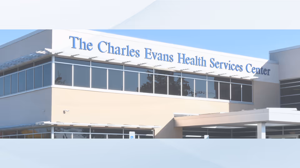 Front exterior of The Charles Evans Health Services Center with glass windows.