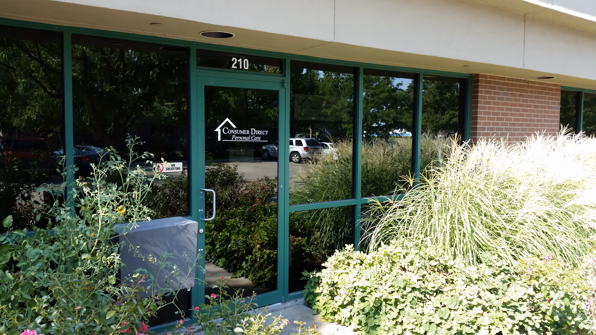 Front entrance of Consumer Direct Care Network Idaho building with glass doors and landscaping.