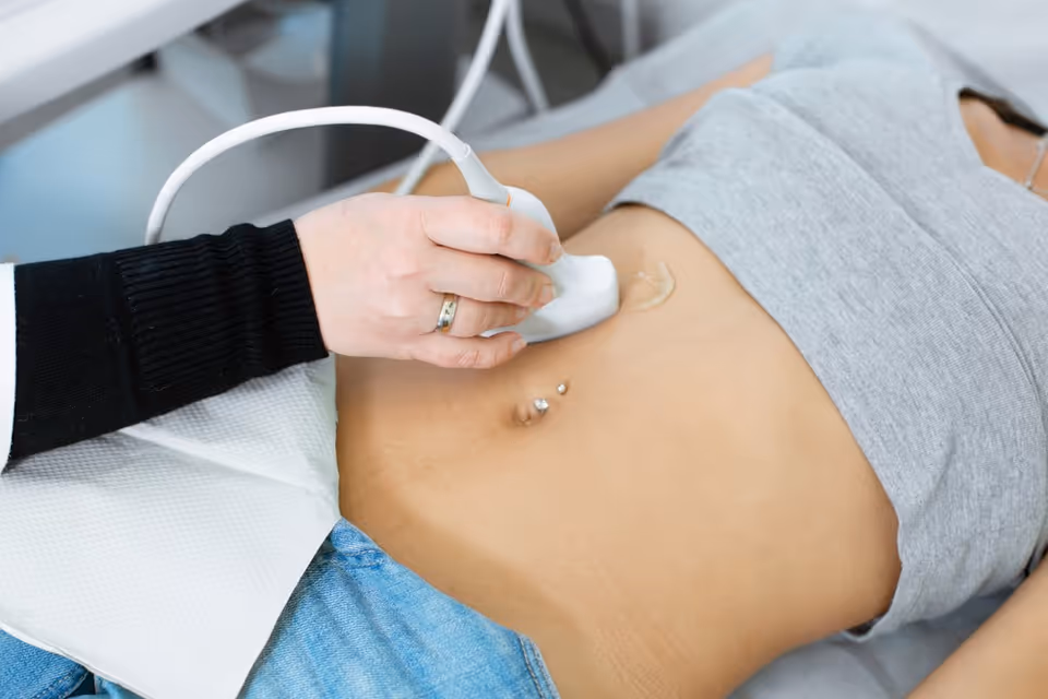 Medical professional performs an abdominal ultrasound on a patient.