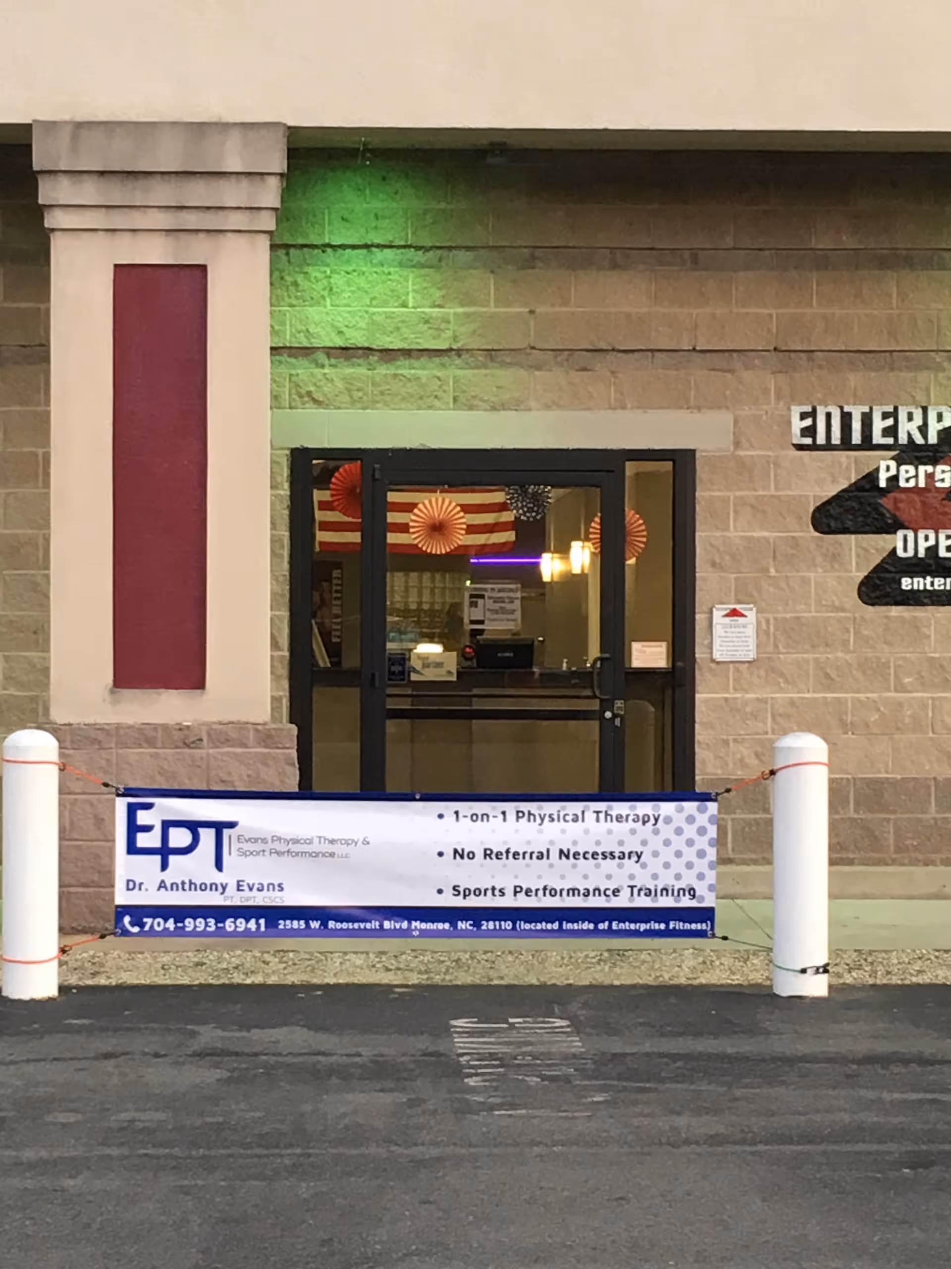 Exterior facility entrance with Evans Physical Therapy banner hung in front.