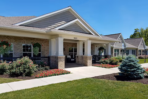 Front entrance of Green Acres Mason senior living facility with brick exterior and landscaped grounds.