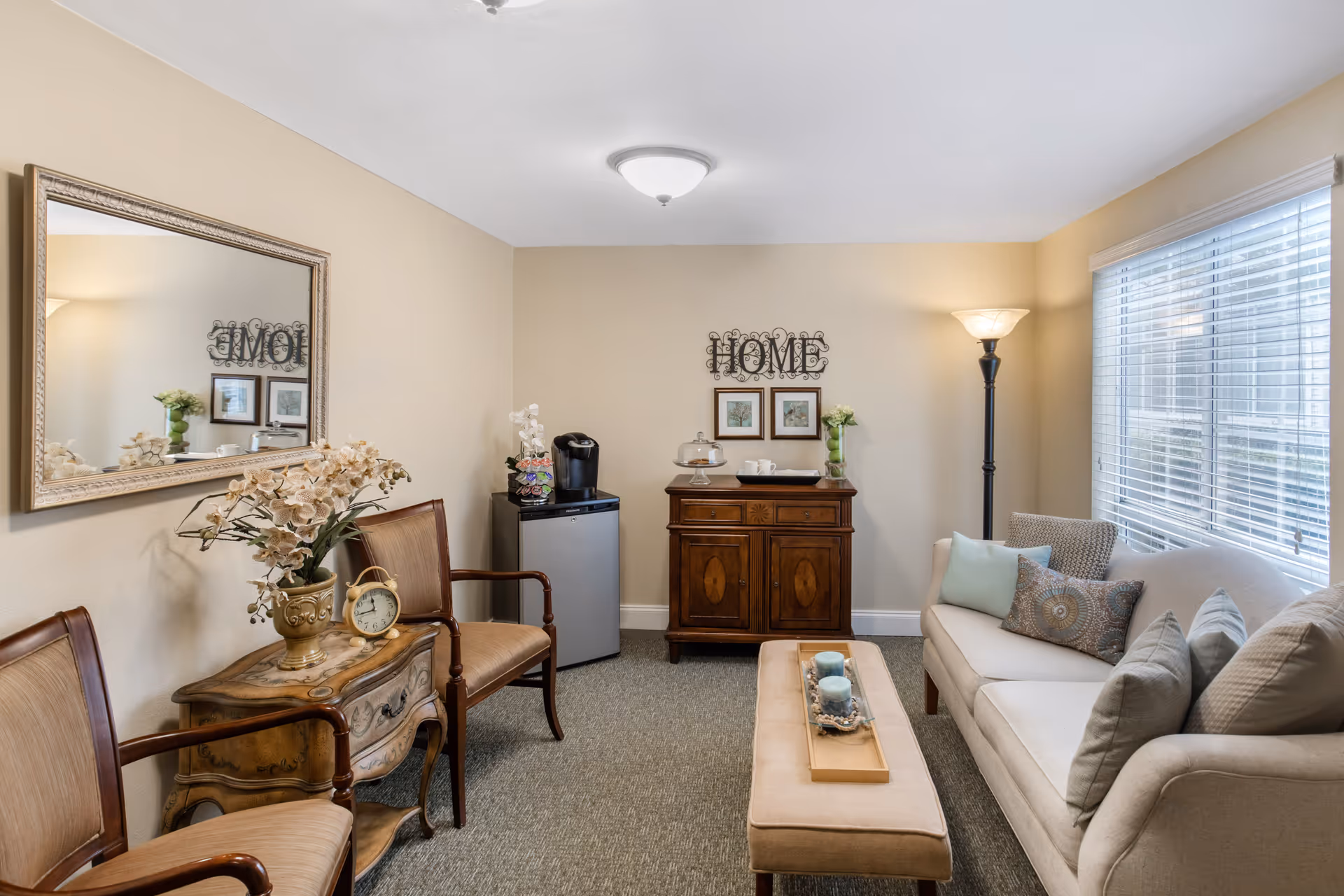 Cozy living room with beige walls, cream sofa, and wooden cabinet